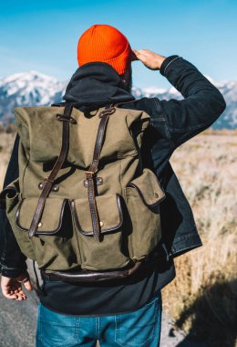 Arkadan görünüşü erkek seyahat tur ABD'de uzakta, dağlar başında seyir hiking sırasında sırt çantası ile vahşi çevre gözlemleyerek ve doğa panoramik manzarayı keşfetmek hipster adam yürüme