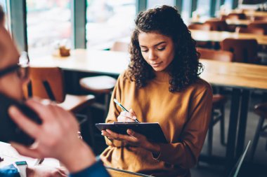 Meşgul genç Afro-Amerikan kadın mimar Beyaz delikanlı ile birlikte masaüstü Üniversitesi'nde oturan beyin fırtınası sırasında hangi smartphone üzerinde konuşmaya çalışırken kroki çizim