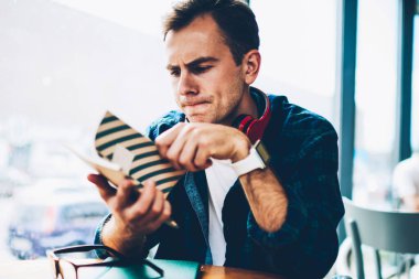 Yakışıklı zeki öğrenci bilgi kafede yaklaşan sınavlar için hazırlarken Defteri'nden okuma görüntü kırpılmış. Yayın için iyi fikirler hakkında iyi görünümlü yaratıcı erkek blogger düşünme