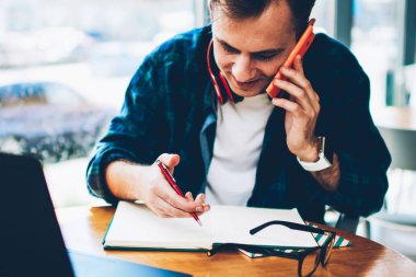 Kurs proje için hazırlanması sırasında komik telefon arkadaş grubu konuşmayı genç olumlu akıllı erkek öğrenci. Smartphone üzerinde konuşmak ve iş programı planlama mutlu vasıflı serbest meslek