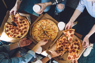 Arkadaşları sıcak bir evde toplanırken, yemek servisi yapan, kutulardan lezzetli pizzalar alan isimsiz insanların en iyi görüntüsü.