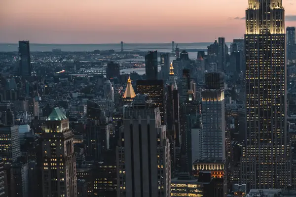 Manhattan 'ın merkezindeki gökdelenlerin ve kulelerin gökyüzü manzarası. Akşam günbatımında gökyüzü. Finansal bölgenin manzarası ünlü New York simgesi, aydınlanmış Empire State Binası