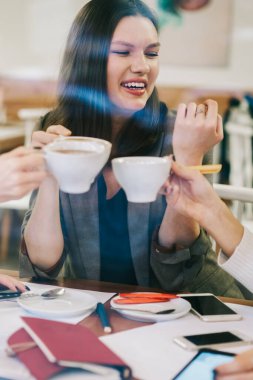 İş kurma projesinde işbirliği yaparken kahve fincanlarıyla tezahürat eden pozitif neşeli hippi kızlar iyi bir arkadaşlık, konsept eğer iletişim...