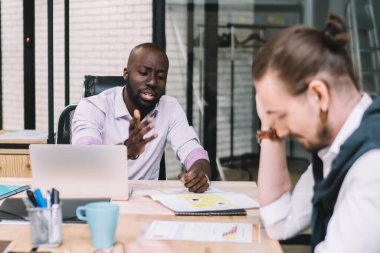 Masaüstünde oturan ve projede işbirliği yapan çeşitli insanlar beyin fırtınası toplantısı, çok kültürlü profesyonel erkek ve kadın iş arkadaşları ofis odasında işbirliği yapıyorlar.