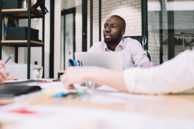 Atölyede çalışırken finansal raporun detaylarını tartışan çeşitli profesyonel ekonomistler, çalışanlar için motivasyon stratejisi konusunda işbirliği yapan akıllı yöneticilerden oluşan bir ekip