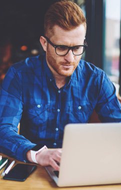 Yeni dizüstü bilgisayar cihazı, modern teknoloji ve iletişim kavramı ile kahve dükkanında uzaktan çalışırken web sitesinde makale için ilginç içerik oluşturma ciddi kafkas erkek metin yazarı