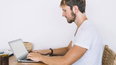 Reklam metni için boş ekranı olan modern netbook üzerinde çalışan ciddi bir erkek yazılım geliştiricisinin yan görüntüsü veya yüksek 4G internete bağlanan web sitesi bilgileriniz, mesafe işi