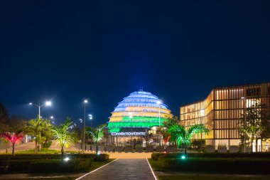 Kigali, Ruanda - 19 Ağustos 2022: Kigali Kongre Merkezi Ruanda bayrağının renginde parladı. Bir kralın sarayından sonra tasarlanan tesis çeşitli etkinliklere ev sahipliği yapabilir.