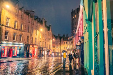 Edinburgh, Scotland - January 22nd, 2024: Victoria Street at night, with lights reflected on the road after rainfall clipart