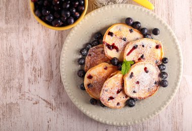 Fresh homemade blueberry pancakes with icing sugar