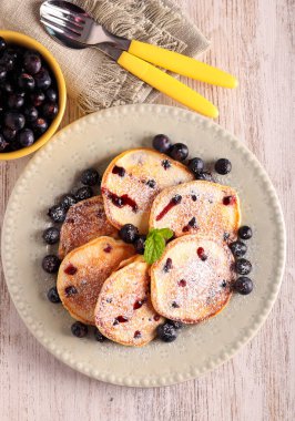 Fresh homemade blueberry pancakes with icing sugar