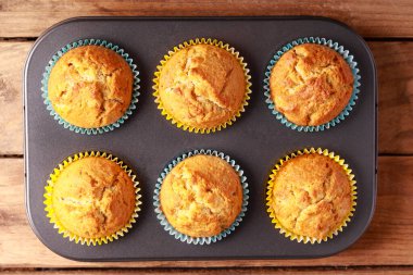 Homemade muffins with crusty topping in a metal tin