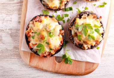 Stuffed portobello mushroom cups on board