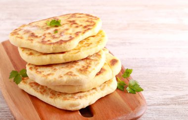 Homemade flatbreads on wooden board