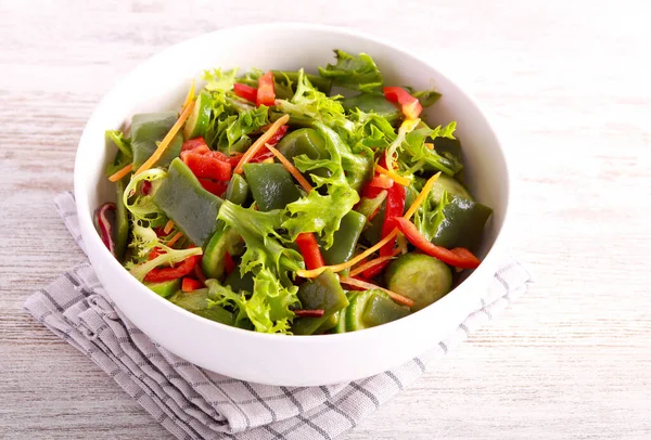 Healthy green salad with green beans, cucumber, pepper and mix leaves