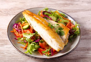 Kızarmış deniz kabuğu fileto salata üzerine.