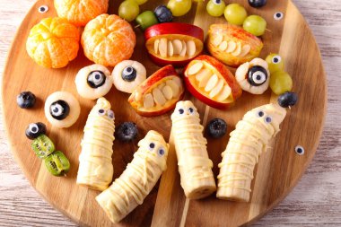 Cadılar Bayramı meyve tabağı. Cadılar Bayramı için süslenmiş çeşitli meyve atıştırmalıkları.