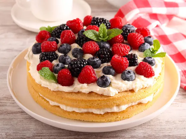 Cream and mixed berry sandwich cake, on plate