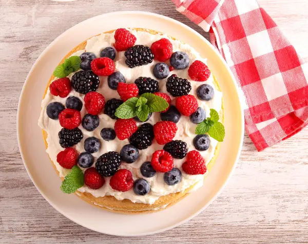 Cream and mixed berry sandwich cake, on plate