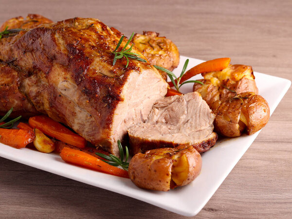 Roasted pork neck with potatoes and carrot