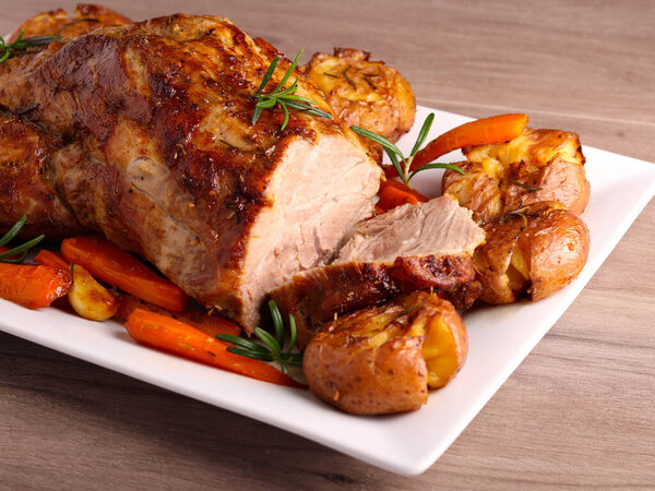 Roasted pork neck with potatoes and carrot