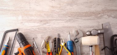 Different tools over wooden background clipart