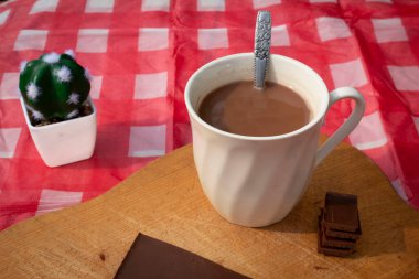 Masada bir fincan sıcak çikolata. Ön manzara. Çikolata Günü için arka plan ya da kart. Tatlı içecek. Kırsal ayar.