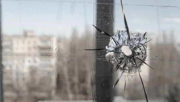 Window shattered by shell fragments. Russian aggression. War in Ukraine. The life of Ukrainians in difficult war times.