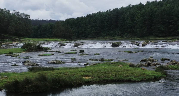 stock image scenic view of pykara waterfall surrounded by lush green forest on the foothills of nilgiri mountains near ooty hill station in tamilnadu, south india