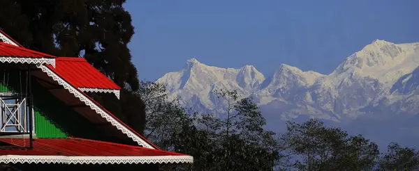 stock image beautiful countryside and outskirts area of darjeeling hill station, snowcapped himalaya mountains backdrop against the blue sky, west bengal, india