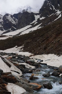 Dağ deresi karla kaplı Alp Vadisi 'nde Rohtang Geçidi' nin yanındaki Marhi 'de, Himalaya Dağları' nda Himachal Pradesh, Hindistan 'da.