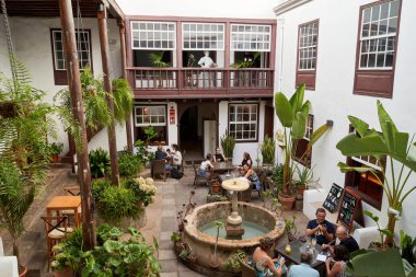 People enjoying an interior terrace of a bar in La Laguna, Tenerife, Spain. 06-06-2024 clipart