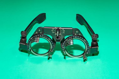 Optometry optics test glasses on a green table. High quality photo clipart