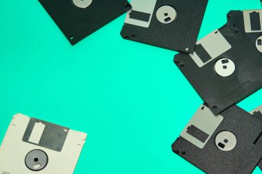 Eski disket koleksiyonu, 90 'lı yılların kalıntıları, turkuaz arka planda.