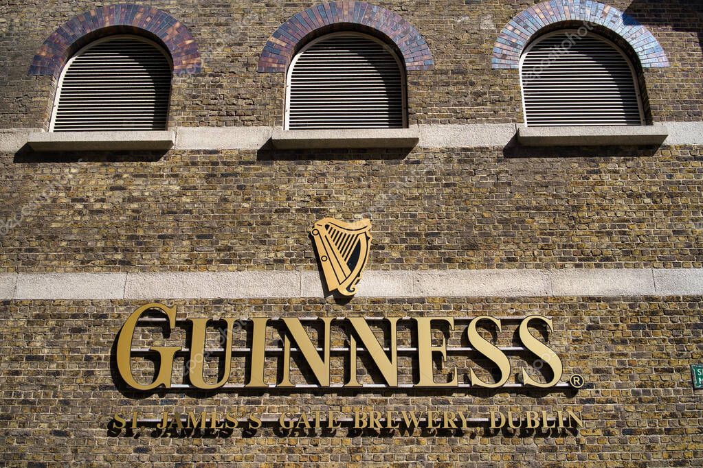 Facade of the Guinness Brewery in Dublin, Ireland, featuring the iconic sign and harp emblem.