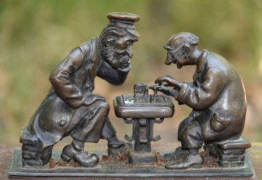 Kyiv, Ukraine July 6, 2024: Statues in the park - Men playing chess in the Taras Shevchenko Park, where amateurs play chess clipart