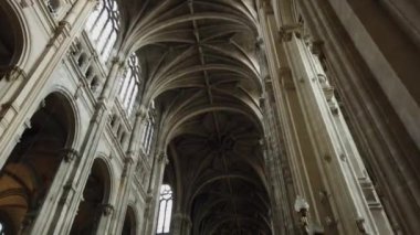 Fransa, Paris 'teki Saint-Eustache Kilisesi' nin görkemli manzarası, yüksek kemerli tavan, sütunlar ve vitray pencereler sergileniyor..