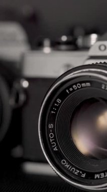 Detail of an old photographic camera with light reflections. Film roll camera.