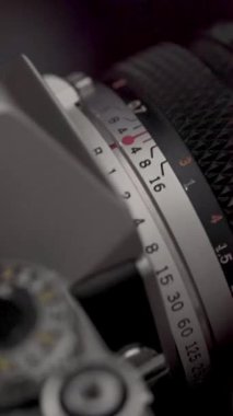 Detail of analog camera from the 80s. Photography of film roll being used.