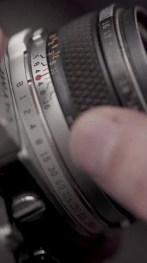 Detail of analog camera from the 80s. Photography of film roll being used.