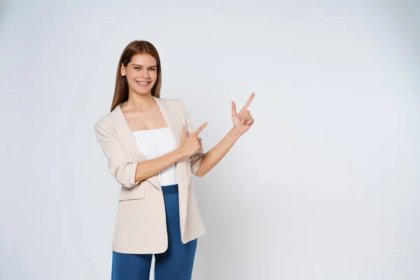 stock image Young mixed race woman pointing to empty copy space isolated on white background.