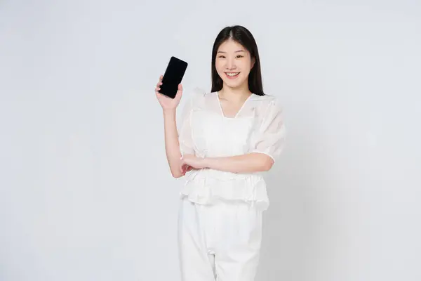 Smiling Asian Woman Holding Mobile Phone While Standing Isolated White — Stock Photo, Image