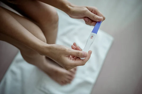 Stock image Close-up of young woman holds a pregnancy test in her hands. Positive pregnancy test.