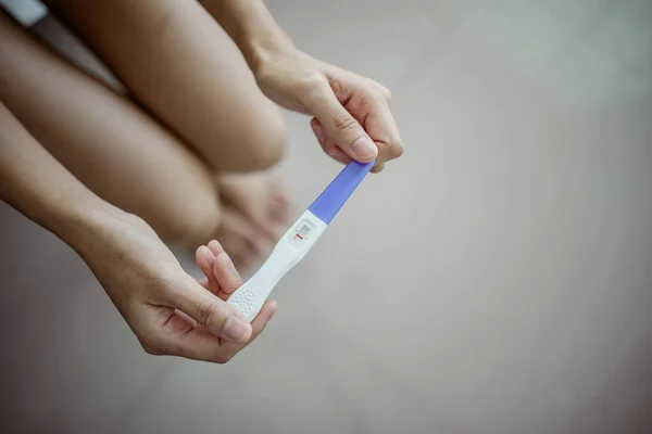 stock image Unhappy young asian woman holding pregnancy test showing a negative result. Healthy and infertility problem concept .