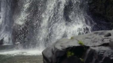 Close up waterfall water splashing on rocks.