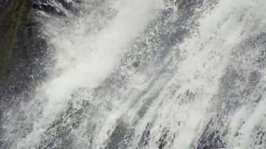 Close up waterfall water splashing on rocks.