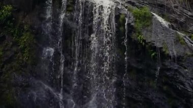 Close up waterfall water splashing on rocks.