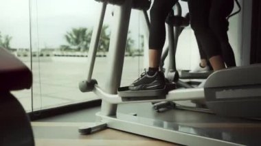 Spor salonundaki kadın koşu bandında koşarak egzersiz yapıyor. Spor salonunda egzersiz yapma kavramı.