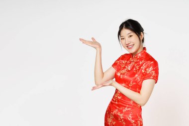 Happy Chinese new year. Asian woman wearing traditional cheongsam qipao dress with gesture of introduce isolated on white background. clipart