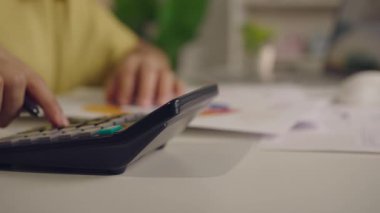 Hesap makinesini kullanarak kadın eli kapat. Ev finansmanı ve yazma notu, masa başı hesaplama, bütçe yönetimi. Finans, bütçe ve vergi hesapları yapmak.